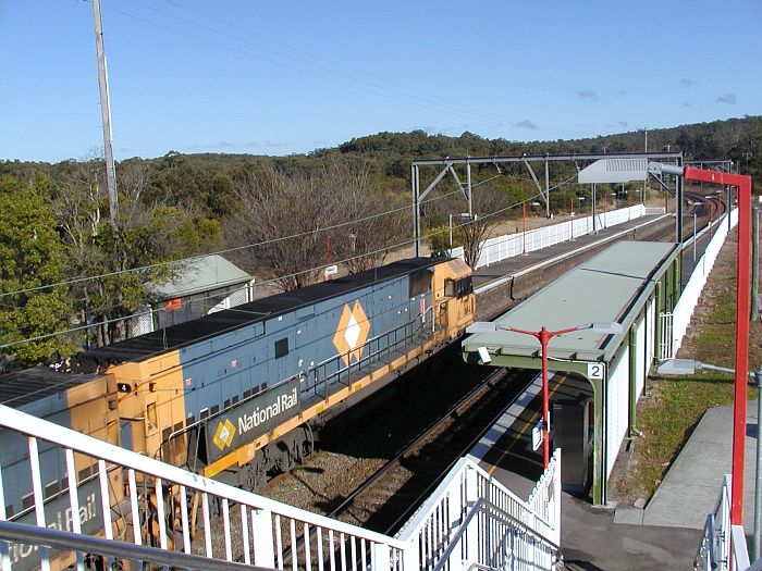 
A southbound National Rail freight train headed by NR4 passes through the
station.
