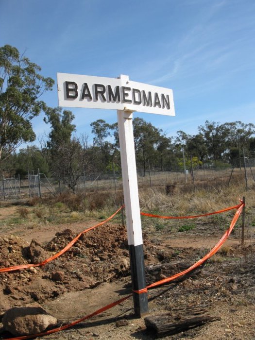 The station name board is still present on the remains of the platform.