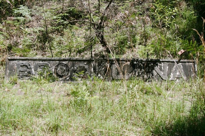 The tracks are overgrown with weeds, grass and worse, however the nameboard is still on the ground held upright by a few stakes.