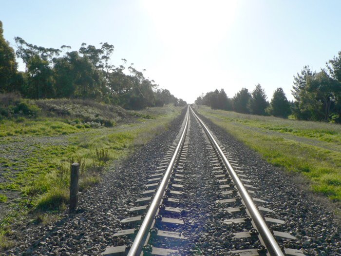 The view looking west. The former station was on the right of the main line.