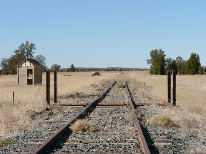 The view looking south towards the former location. Visible are the weighbridge shed and the loading bank. The station was located directly opposite the bank.