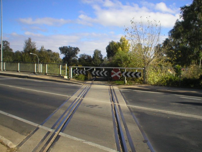 The Mid Western Hwy crosses the Eugowra branch on the level at the eastern end of the main street of Cowra. This view shows the Eugowra branch looking towards West Cowra.