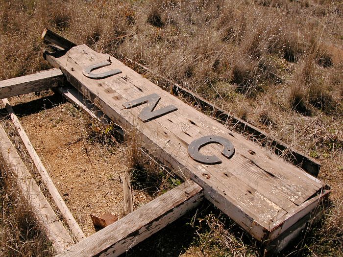 
The remains of the station nameboard lie on the platform.
