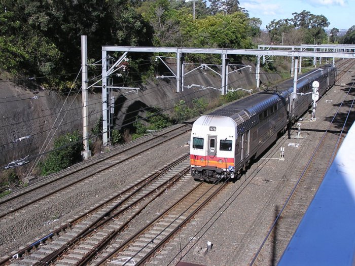 V22 proceeds northwards into Eastwood Station, viewed from West Pde.