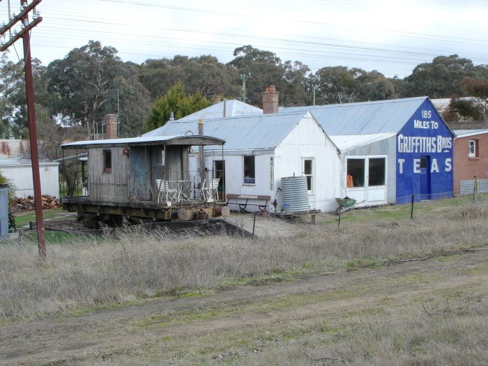 A nearby property contains various railway artifacts including one of the station benches.