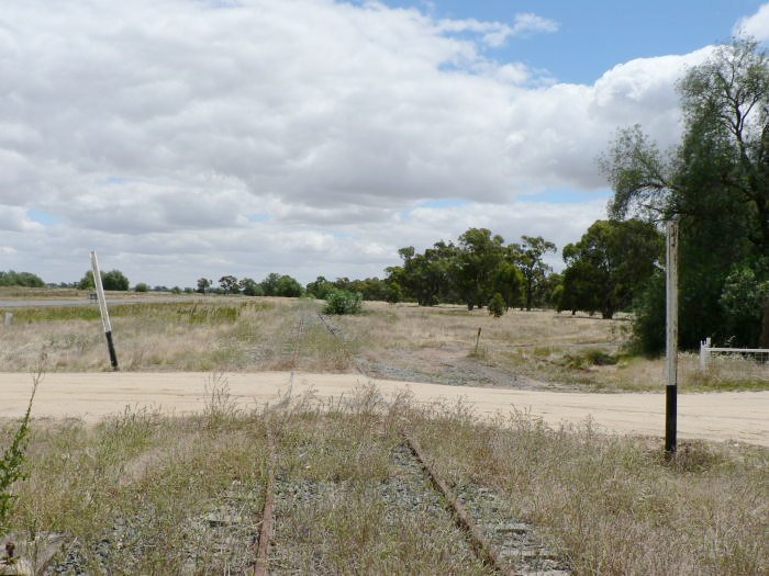 The view looking north. The former station was on the right, just beyond the crossing. On the left were goods and loop sidings, now lifted.