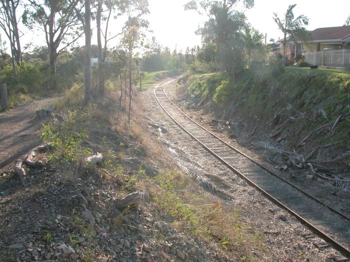 After passing under the Pacific Highway the line turns to the left to follow the Manning River. This view is taken from the top of a cutting between the track and the river looking back towards the highway bridge