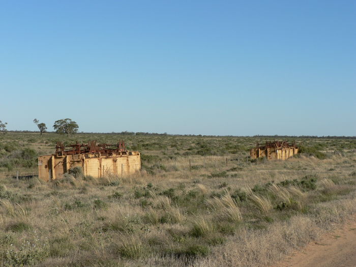 The remains of some upturned railway wagons.