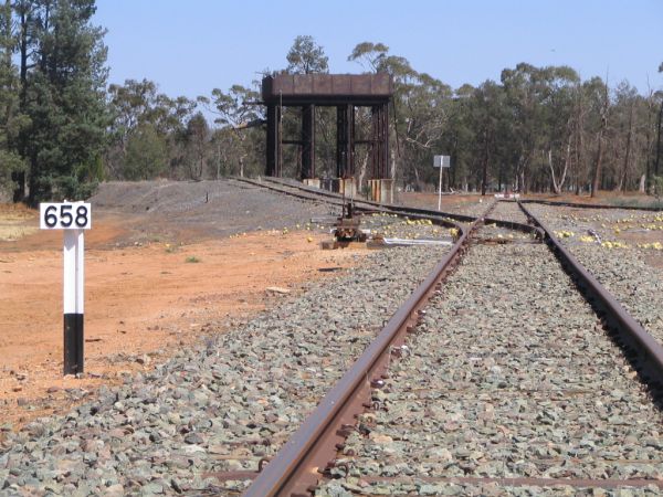 A 658km distance marker and water tower looking west at the terminus.