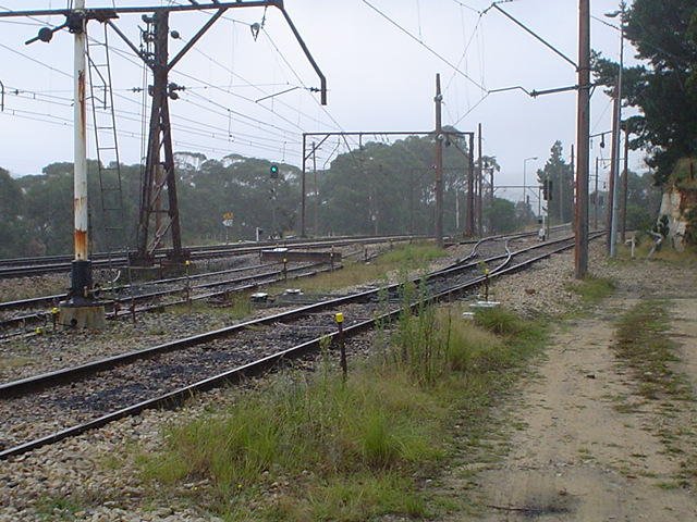 The view looking west of the coal loop arrival/departure road. Beyond that is the now-truncated refuge loop with stop block. At the rear are the main lines.
