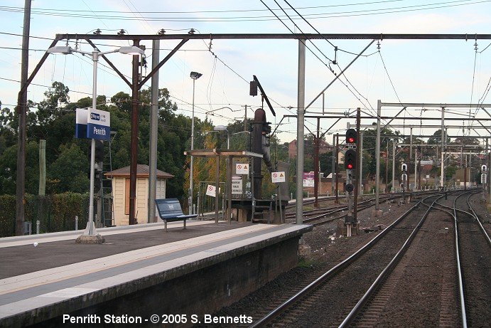 A view of Penrith Railway station showing the old water filling tower at the eastern end of platforms 1 and 2. Photo taken from rear of a Blue Mountains train looking east. The track on right of photo is Down main with the Up main to the centre of photo.