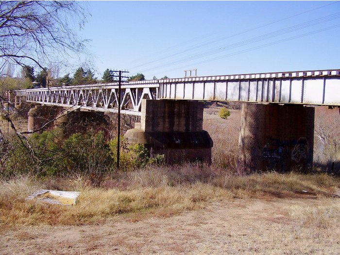 The single line from Queanbeyan crosses the Queanbeyan River just east of the station before turning north and heading for Goulburn.  This is a view of the bridge from the western side looking towards Goulburn.