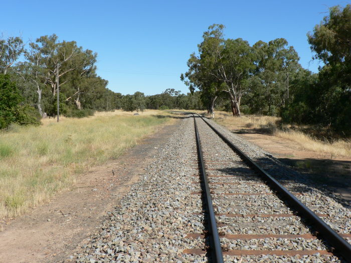 The view looking east.  On the left was a tank, loading bank, goods and loop sidings.  On the right was a platform and signal box.