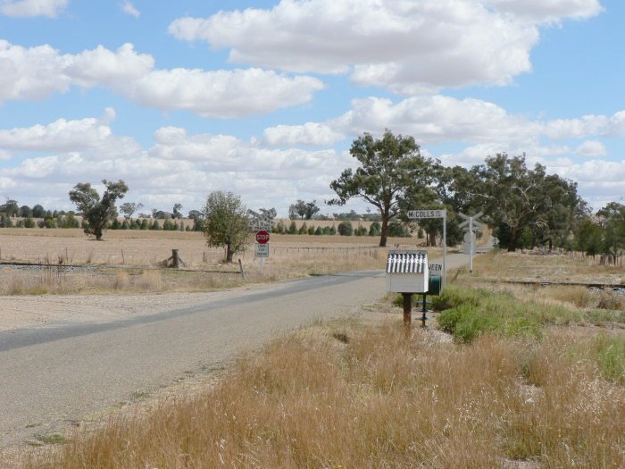 The view looking west through the level crossing. The former station was location on the right hand side, on the far side of the line.